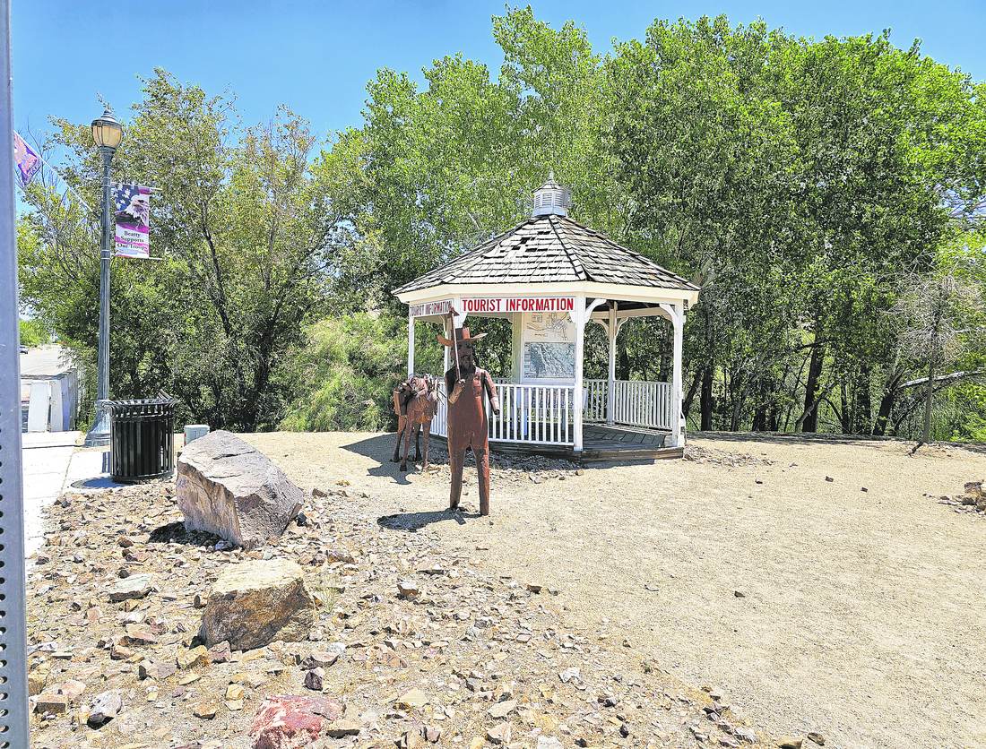 The Beatty tourist information gazebo beside an iron sculpture of a prospector leading a loaded burro